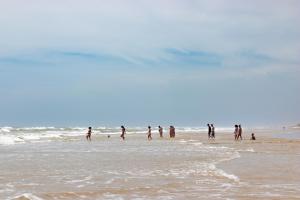 a group of people walking on the beach at Vila Girassol in Aracaju