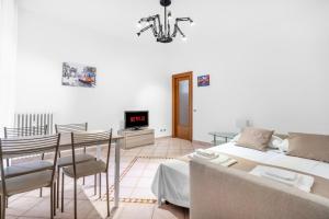 ein Wohnzimmer mit einem Bett, einem Tisch und Stühlen in der Unterkunft Casa da Suite Cavour in Corsico