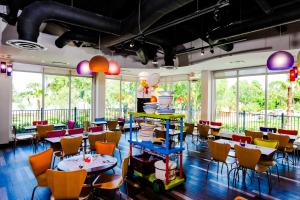 a restaurant with colorful tables and chairs and windows at LEGOLAND® Florida Resort in Winter Haven