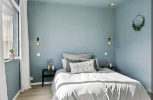 a bedroom with blue walls and a large bed at Modern house near the ocean in Sandefjord