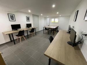 an office with two desks and chairs and two computers at Studio & Coworking Thème Factory A in Morsang-sur-Orge