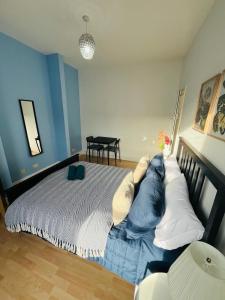 a bedroom with a large bed and a table at Stay and Explore Easy Central London Access via Jubilee Line in London