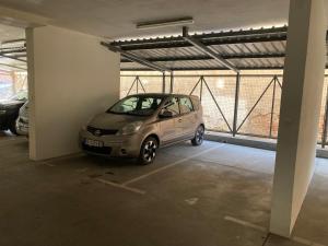 a small car parked in a parking garage at Apartmani Simić Quatro in Valjevo