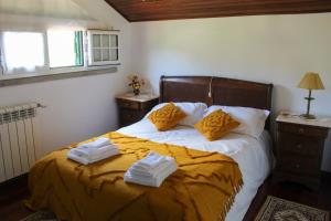 una camera da letto con un letto e asciugamani di Paço AL a Monção