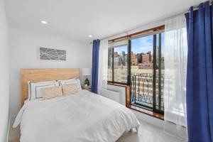 1 dormitorio con cama y ventana grande en 75-5C 3BR LUXURY Duplex BRAND NEW W&D Elevator, en Nueva York