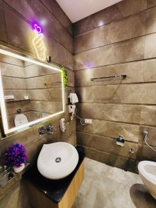 a bathroom with a sink and a toilet and a mirror at HolidayVilla-A Residential Boutique Hotel-Newly Renovated in Amritsar