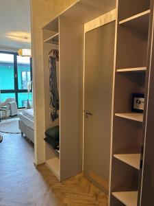 ein Zimmer mit einem offenen Schrank mit einer Tür in der Unterkunft PHIL & MAX Messe Hotel und Apartments in Hannover
