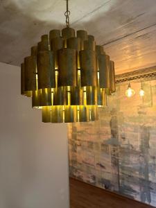 a large bronze chandelier hanging from a ceiling at PHIL & MAX Hotel und Apartments in Hannover