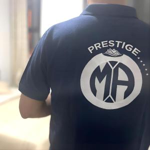 a person wearing a blue shirt with the words prestigema at Abu Dhabi Center - Unique Bed Space in Abu Dhabi