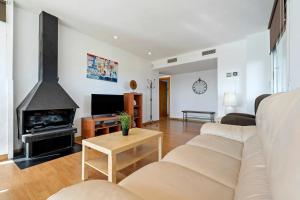 a living room with a couch and a fireplace at Can Montclar - Preciosa casa cerca de Cambrils in Tarragona