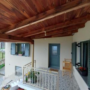 a porch of a house with a wooden ceiling at Theasis home 