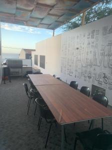 a conference room with a large wooden table and chairs at Palmira House in Cidade Velha