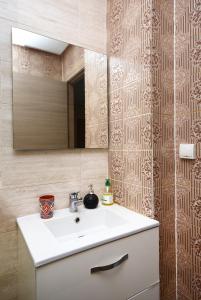 bagno con lavandino bianco e specchio di Appartement Prestegia JAAD Near Aeroport a Marrakech