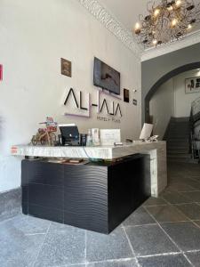 an office with a desk with a sign on the wall at Hotel Alhaja in Puebla