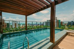a swimming pool on the roof of a building at Summer by Hosppedar in Ilha da Restinga