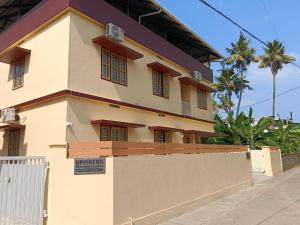 a house with a fence in front of it at Greenview Royal Stay Near Amrita Hospital Edappally in Cochin