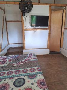 a room with a bed and a flat screen tv at Hotel santa marta Melgar in Melgar