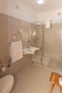 a bathroom with a toilet and a sink and a shower at Mareta View - Boutique Bed & Breakfast in Sagres
