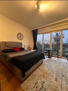 a bedroom with a large bed and a large window at Beauty stüdyo Home in Istanbul
