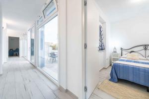 a bedroom with a bed and a sliding glass door at Apartment in Cala Gonone - Nuoro (Provinz) 48226 in Cala Gonone