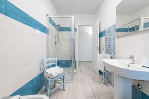 a bathroom with a sink and a toilet and a shower at Apartment in Cala Gonone - Nuoro (Provinz) 48226 in Cala Gonone