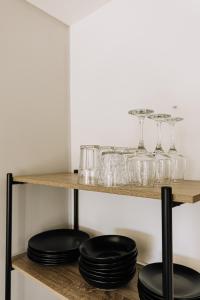 a shelf with glasses and plates on it at Allegra House in Zagreb