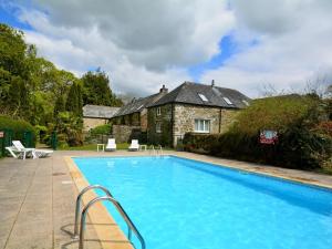 a swimming pool in front of a house at 2 Bed in Looe 47667 in Liskeard