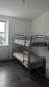 two bunk beds in a room with a window at Sarsfield Hostel in Dublin