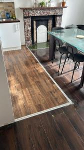 a dining room with a table and a fireplace at Sarsfield Hostel in Dublin