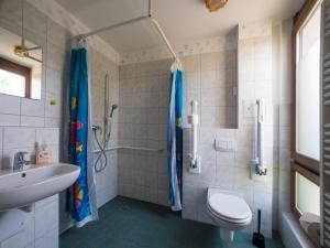 
a bathroom with a shower, toilet and sink at Hotel GreifenNest in Rostock
