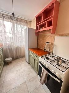 a kitchen with a stove and a refrigerator at Cozy apartment in Galati in Galaţi
