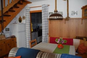 a kitchen with a table with a vase of flowers on it at Appartement Bergfrieden in Oberstaufen