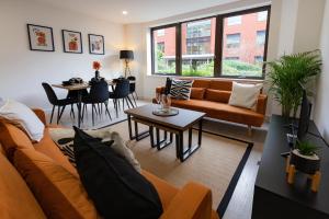 a living room with a couch and a table at Modern City Centre Apartment in Exeter