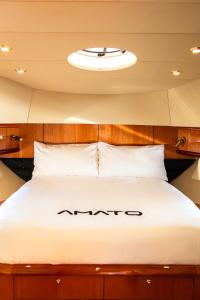 a bed in the middle of a room at Luxury Yacht "Amato" in Sanremo