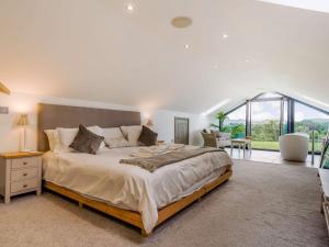 a bedroom with a large bed and a large window at 3 Bed in Bovey Tracey 64380 in Bovey Tracey
