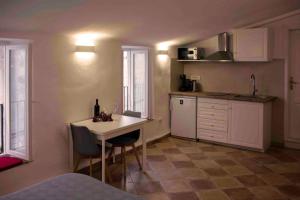 a small kitchen with a table and a counter at Pocco Andante in Dubrovnik