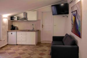 a living room with a couch and a kitchen at Pocco Andante in Dubrovnik