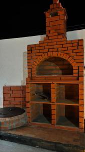 an outdoor brick pizza oven with a brick at شاليه الرتيل in Ash Shuwaybiţ