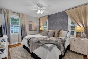 a bedroom with a bed and a ceiling fan at Mayfair Hideaway: 3 Bed 2 Bath Savannah BnB in Savannah