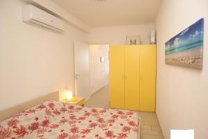 ein Schlafzimmer mit einem Bett und einem gelben Schrank in der Unterkunft Vacanze da Favola in Castelsardo