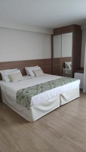 Ένα ή περισσότερα κρεβάτια σε δωμάτιο στο Vista Azul Apartamento - hospedagem nas montanhas