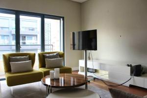 - un salon avec un canapé et une télévision dans l'établissement 2 bedrooms apartement with shared pool and wifi at Lisbon, à Lisbonne