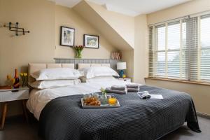 a bedroom with a bed with a tray of food on it at The Tackhouse in Greenlaw