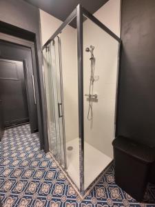 a shower with a glass door in a bathroom at La Bulle in Liévin