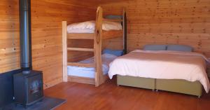 a bedroom with two bunk beds and a stove at Panorama Peace Nature in Castlewellan