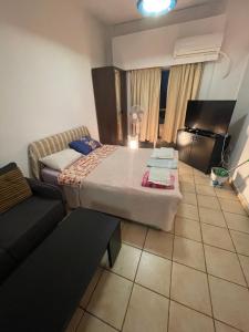 a room with a bed and a couch in it at Studio apartment in Larnaca