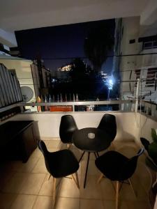a table and chairs on a balcony at night at Studio apartment in Larnaca