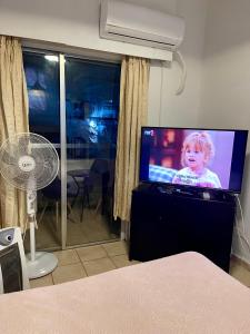 a flat screen tv sitting in a living room at Studio apartment in Larnaca