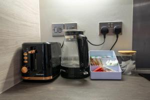 a coffee maker sitting on a counter next to a box at Luxury City Centre Apartment (Weekly Booking) in Hull