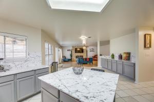 a large kitchen with a white counter top at Austin Home with Deck - 9 Mi to Zilker Park! in Austin